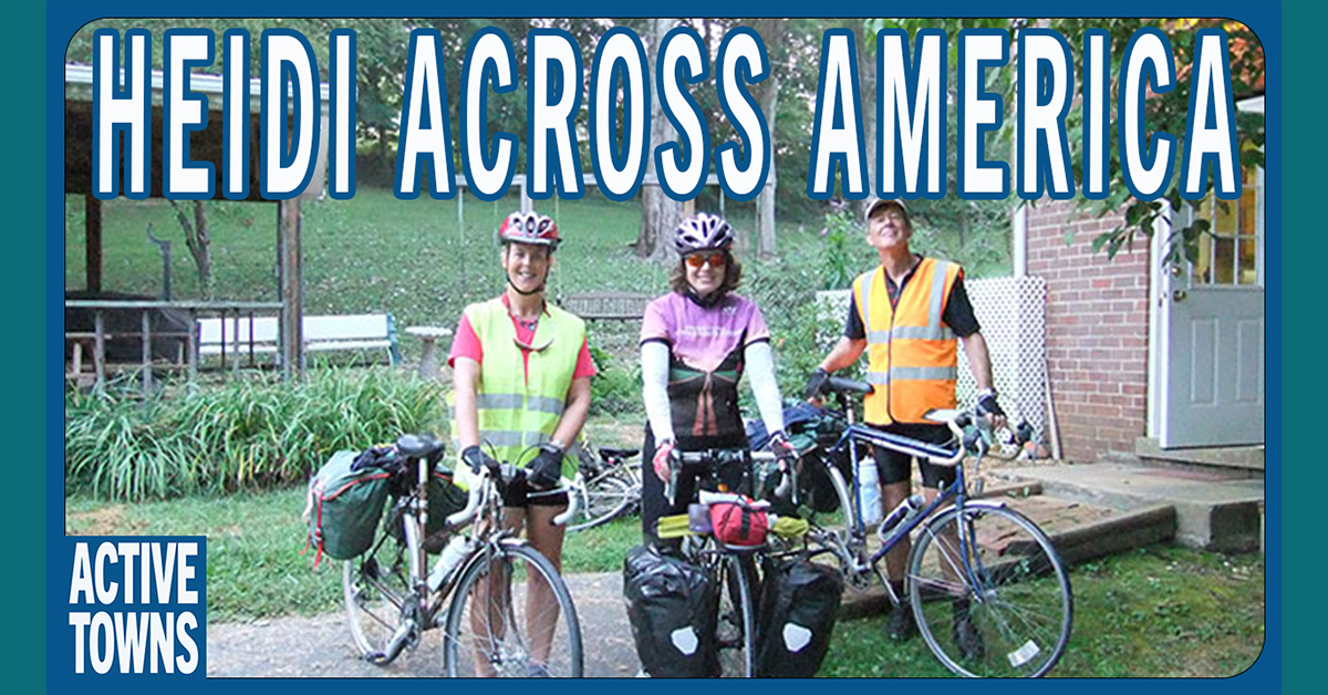 Three people standing with their touring bikes