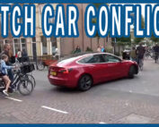 Children trying to ride to school with cars blocking the street