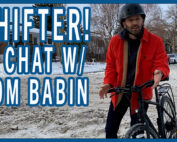 Tom with his bike in a dirty snow clogged intersection