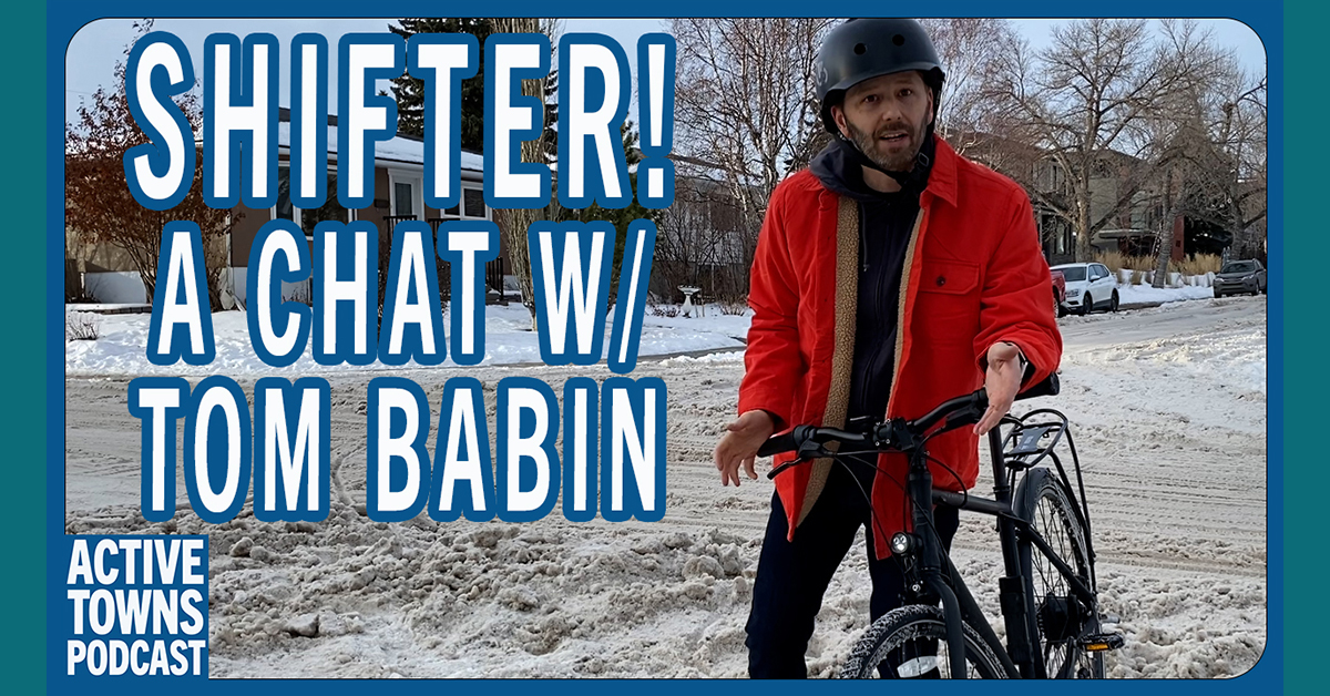 Tom with his bike in a dirty snow clogged intersection