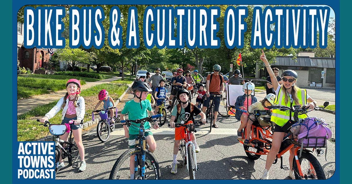 A large group of bike bus participants posing for a group photo